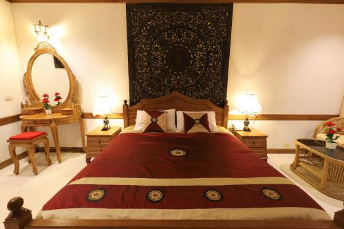 a bedroom with a large bed with a red blanket at Right Spot in Pattaya South