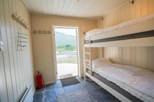 a room with two bunk beds and a window at Røde Kors ground floor in Brunstad