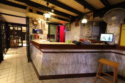 a bar in a restaurant with a counter and a stool at Right Spot in Pattaya South