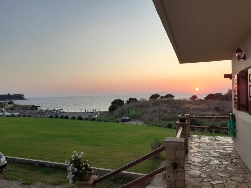 a sunset view from the balcony of a house at Armiriki Apartments in Korakokhórion