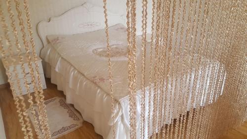 a bed with a canopy with chains on it at Hyuratun in Vanadzor