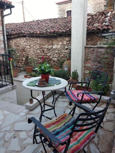 a table and chairs sitting on a patio at Proselinos in Dhimitsana