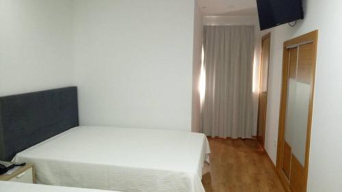 Giường trong phòng chung tại Hotel Bem Estar