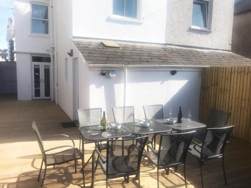 a table and chairs sitting on a patio at 143 New Road Porthcawl in Porthcawl