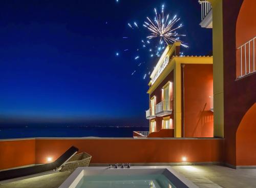 a view of the ocean from a house at night at Hotel Lorelei Londres in Sorrento