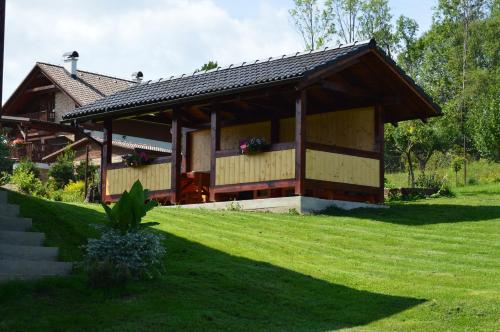 a large building with a grassy yard in front of it at Apartment Lazoň in Pavčina Lehota