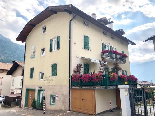 a building with flower boxes on the side of it at Apartments Trettel in Tesero
