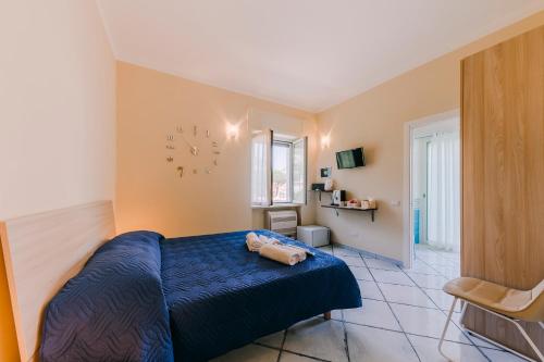 a bedroom with a blue bed and a clock on the wall at Peppa Room in Ravello