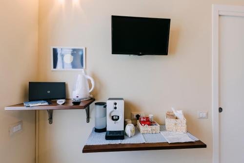a room with a table with a coffee maker and a tv at Peppa Room in Ravello