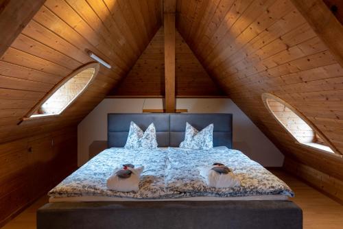 a bedroom with a bed with two birds on it at Landgasthof Farnsburg in Ormalingen