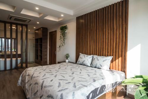 a bedroom with a large bed with white sheets at Irest Apartment in Hanoi