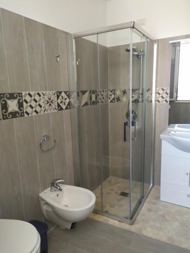 a bathroom with a shower and a toilet and a sink at Naxos Laguna Beach in Giardini Naxos