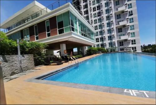 a large swimming pool in front of a building at Feels Like Home Condos Abreeza Place Tower 1 & 2 in Davao City