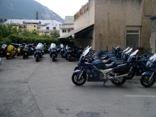 a group of motorcycles parked in a parking lot at Hôtel Mont-Brison in Briançon