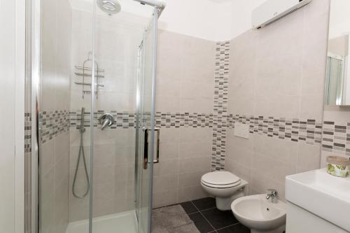 a bathroom with a shower and a toilet and a sink at Apartment A lago private beach and parking in Oliveto Lario