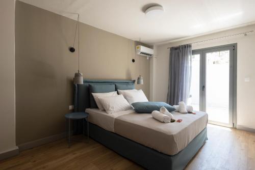 a bedroom with a bed with two stuffed animals on it at GroundFloor 2BR Apt with Smallyard near the heart of Kalamata in Kalamata
