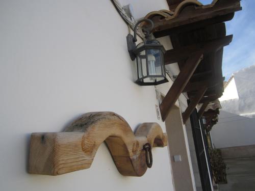 a wooden horse on the side of a building with a lamp at Apartamentos Venta Don Quijote in Almagro