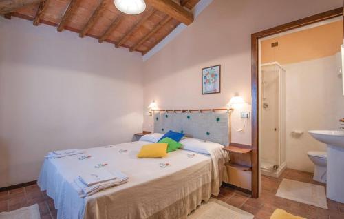 a bedroom with a large bed and a sink at Podere San Guglielmo in Sarteano