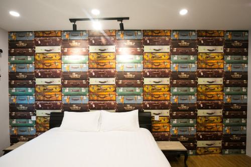 a bedroom with a wall of books at Canning 33 in Ipoh