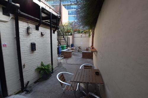 an outdoor patio with a wooden table and chairs at The Crow Inn in Sheffield