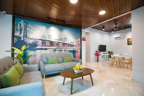 a living room with a large painting on the wall at Canning 33 in Ipoh