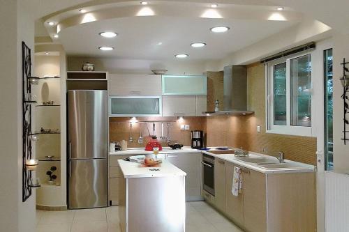 a kitchen with a sink and a refrigerator at A1 Elegant Vouliagmeni apt in a Unique Spot in Athens