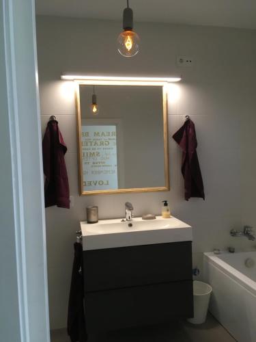 a bathroom with a sink and a mirror and a tub at Montserrat in Calonge