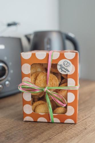 a box of donuts with a bow on a table at KaksTeist Apartments in Haapsalu