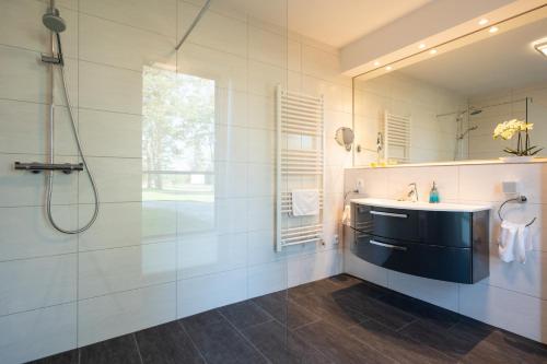 a bathroom with a sink and a shower at Terrassenwohnung "Haffparadies" - Oase am Haff in Garz-Usedom