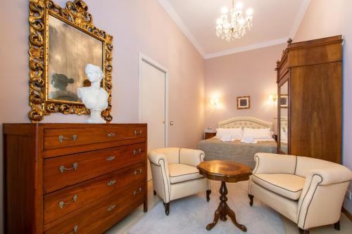 a bedroom with a bed and a dresser and a mirror at Sant'Ivo Apartments in Rome