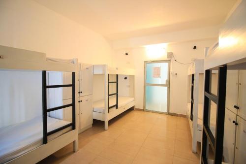 a room with two bunk beds and a hallway at Clock Inn Dehiwala in Mount Lavinia