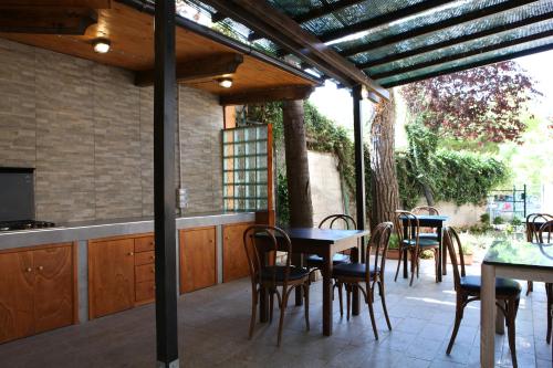 un patio al aire libre con mesas y sillas y una cocina en La casa di nonno Giulio, en Porto SantʼElpidio