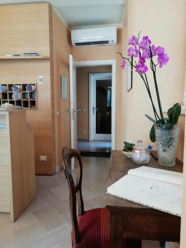 a kitchen with a table with a vase of flowers on it at Locanda della Maria in Bellagio