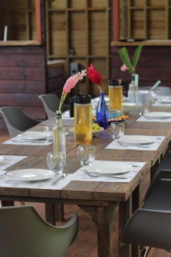 una mesa de madera con platos y copas de vino. en Ataraxia, en Bastimentos