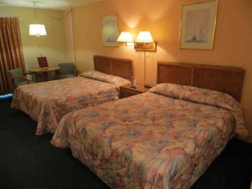 Ένα ή περισσότερα κρεβάτια σε δωμάτιο στο Starlite Budget Inn