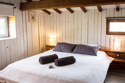 a bedroom with a white bed with two pillows on it at Suite l'Escoundudo in Aix-en-Provence