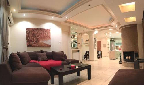 a living room with a couch and a table at A1 Elegant Vouliagmeni apt in a Unique Spot in Athens