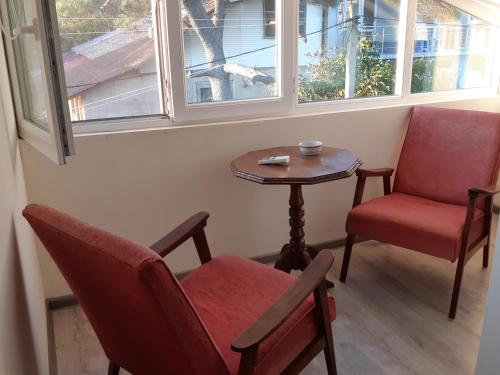 a room with two chairs and a table and a window at Ureki GuestHouse in Ureki