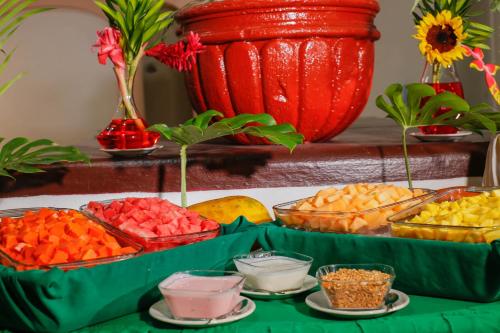 a table topped with bowls of different types of fruit at Hotel Costa Brava in Manzanillo