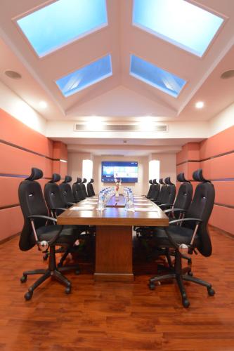 a conference room with a large table and chairs at Islamabad Regalia Hotel in Islamabad