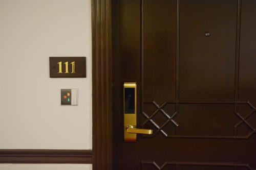 a black door with a gold door knob on it at Islamabad Regalia Hotel in Islamabad
