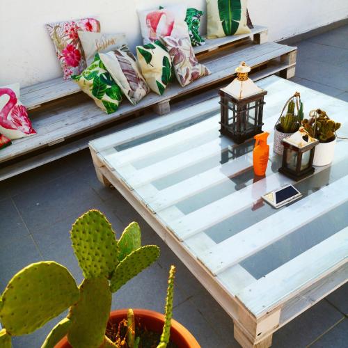 a bench with pillows and a lamp and a cactus at Flamingo B&B in Pompei