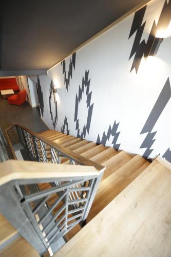 a room with stairs and a wall with black arrows at SPA HOTEL Gora in Bukovel