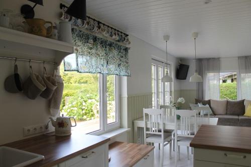 a kitchen and living room with a table and chairs at Villa Orissaare in Orissaare