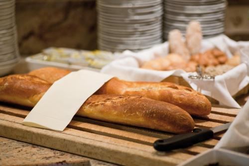 a bunch of loaves of bread sitting on a table at Hotel Neue Post in Hippach