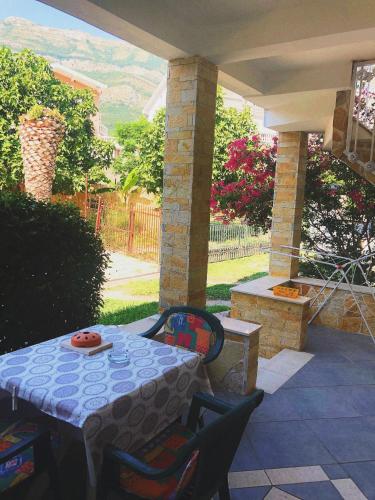 a patio with a table and chairs on a patio at Vila Jovana in Sutomore