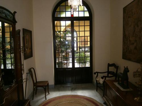 a room with a black door and a window at Casa San José in Palma del Río