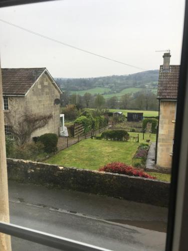 a view of a garden from a window at Garstoncottage in Bath