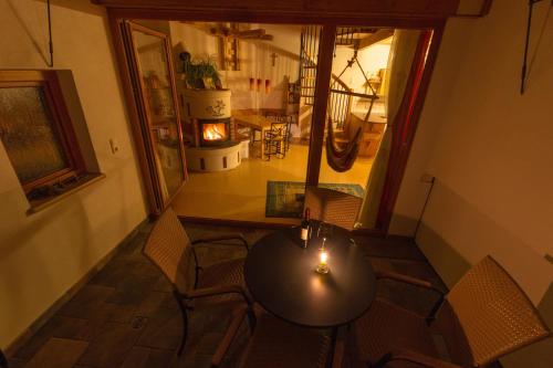 a table and chairs in a room with a hallway at Bioferienhof Brückler in Laussa