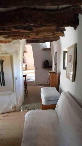 a bedroom with a bed and a chair in a room at Stone house by Anemos in Agios Ioannis